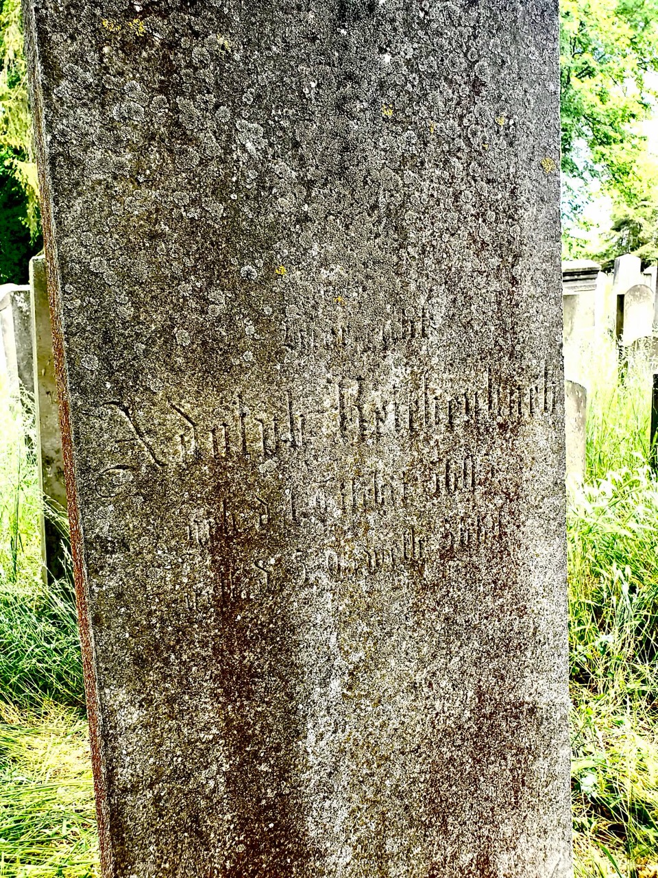 Present-condition photograph of the weathered German face of Adolph Reichenbach’s gravestone in Halberstadt