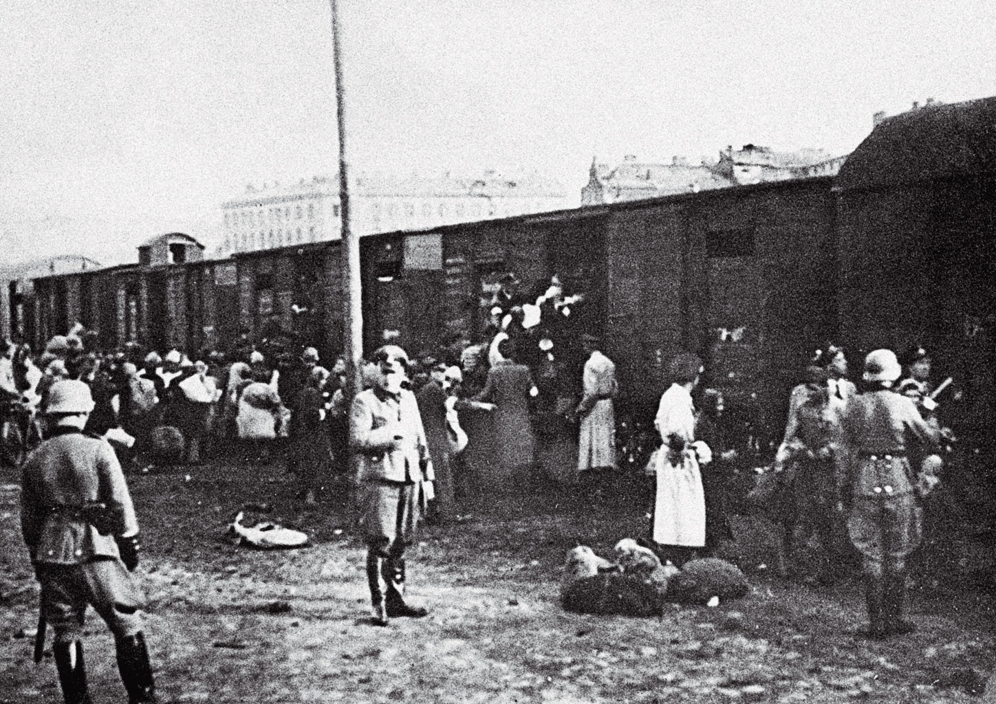 Jews loading belongings onto railway freight cars at the Warsaw Umschlagplatz during the German occupation.