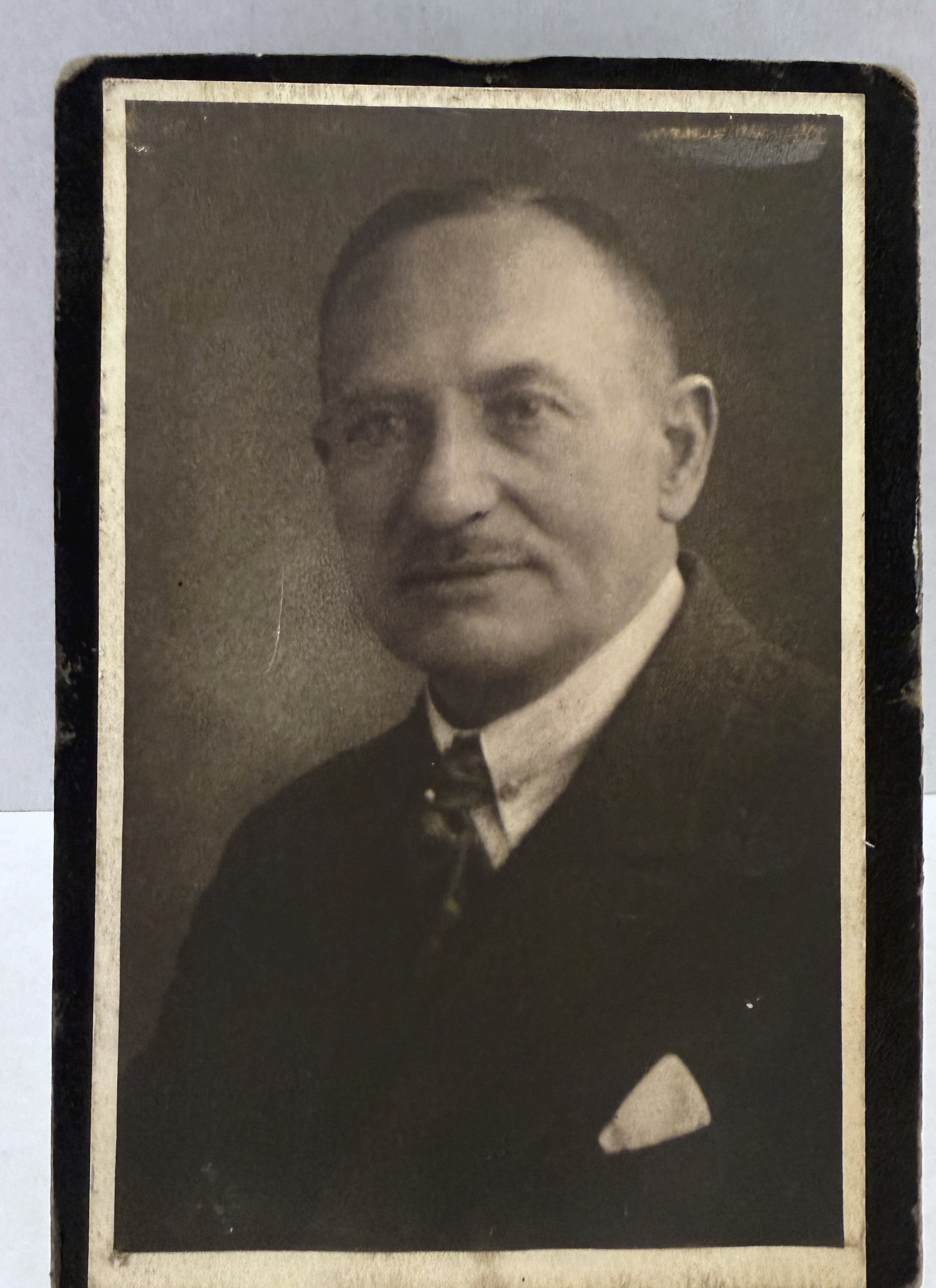 Studio portrait of Philipp Liebenthal wearing a dark suit and light pocket square
