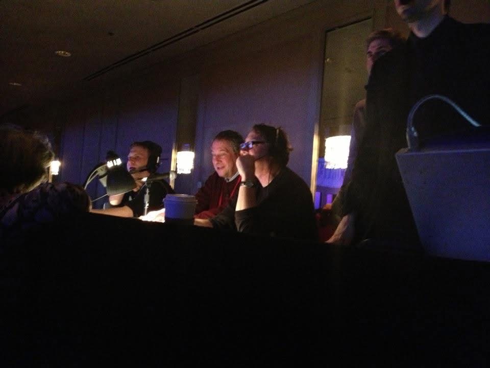 Paul J. Reichenbach seated at a URJ Biennial announcer booth beside Loui Dobin at the sound controls
