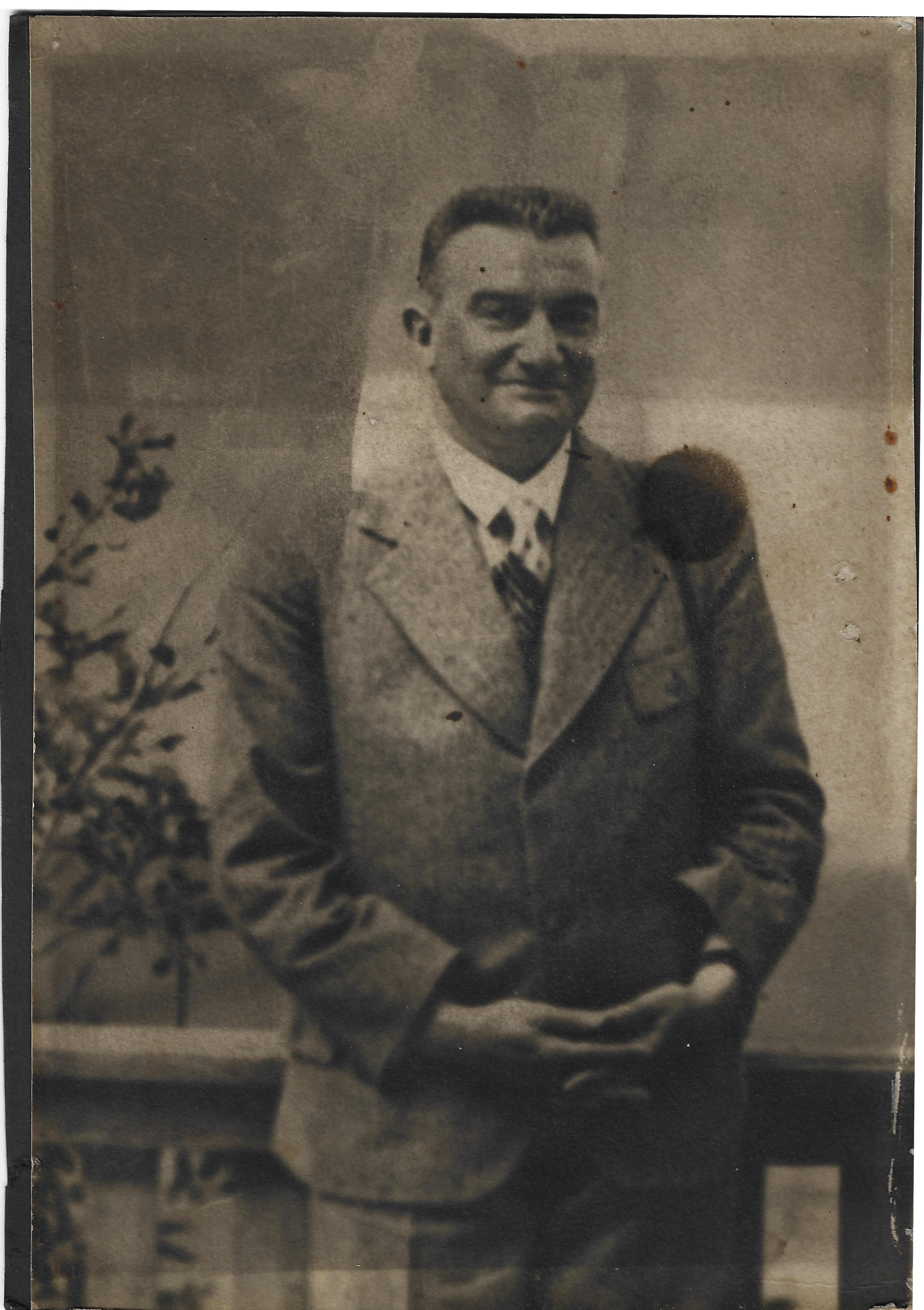 Paul Reichenbach standing near a terrace railing in a suit