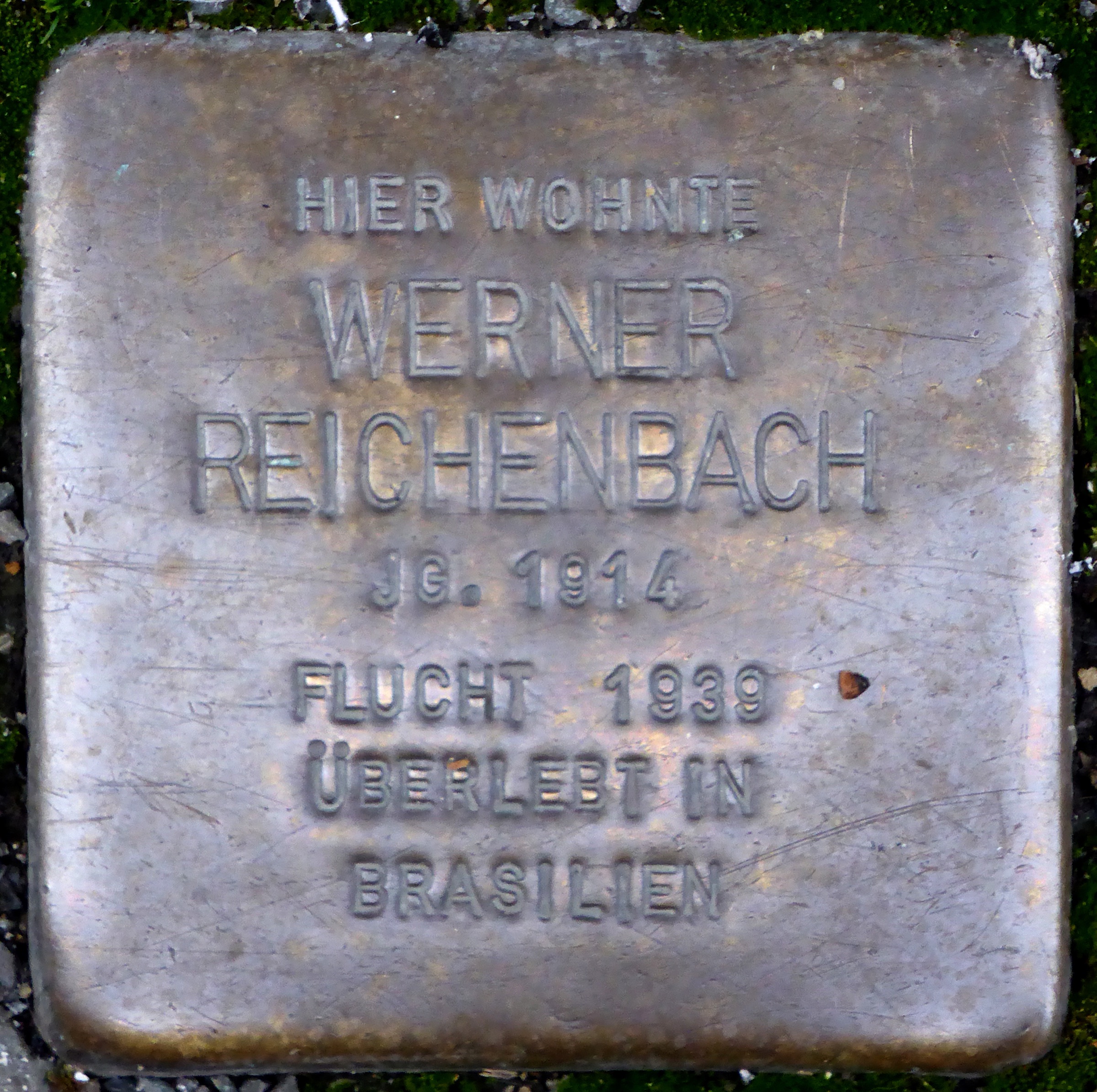 Brass Stolperstein at Breite Straße 7 naming Werner Reichenbach